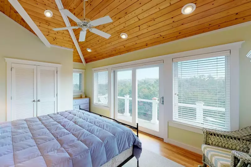 Great views from the bedroom can be had inside or on the private deck with seating