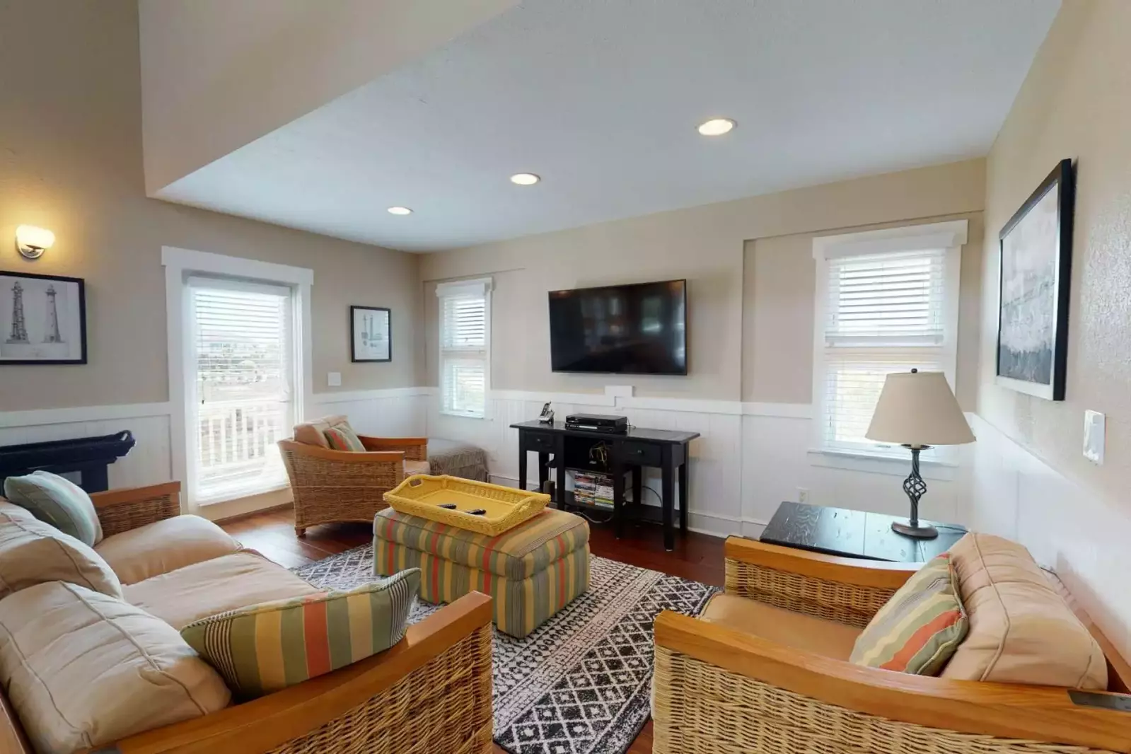 The living area has plenty of comfortable seating and a large screen TV
