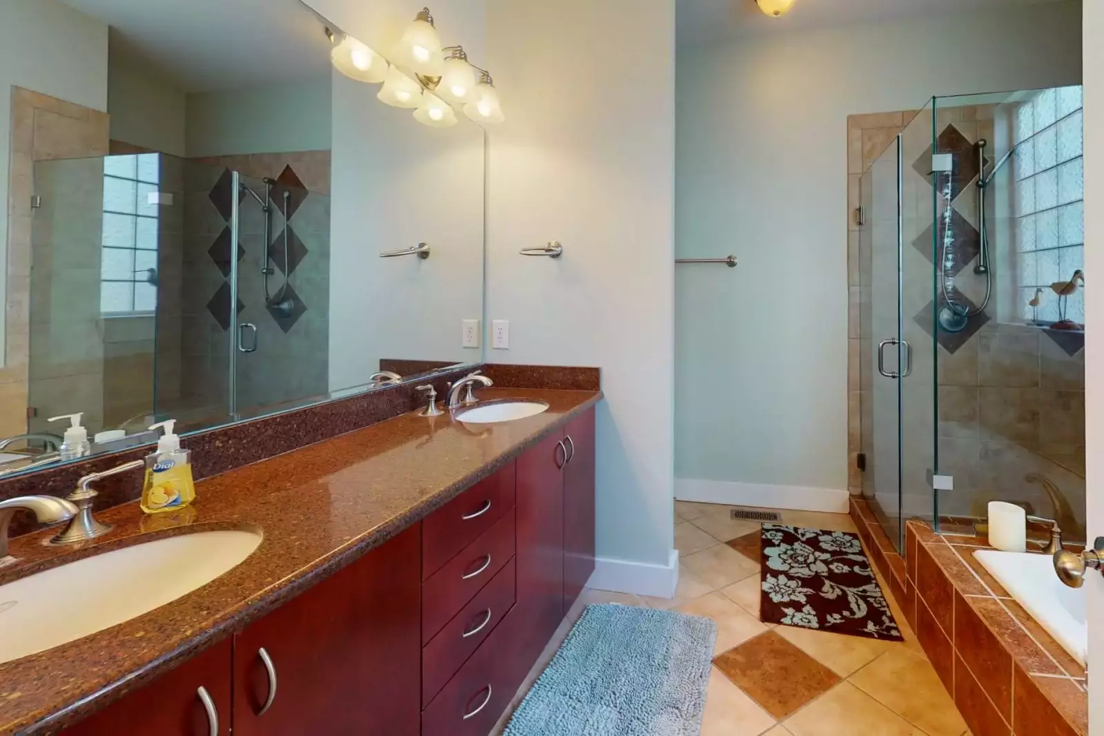 Top floor owners suite has a large bathroom with double vanity sinks and a spacious tub to relax in after a long day at the beach!