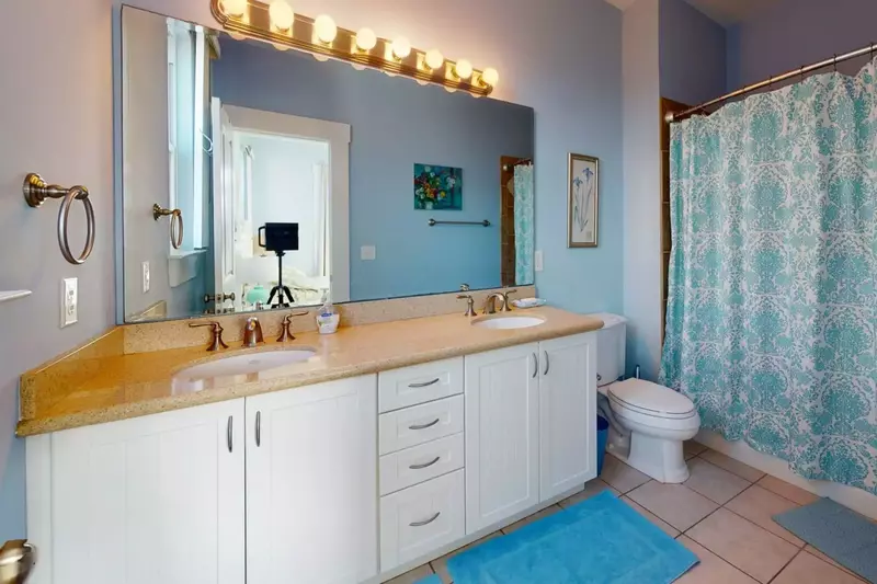 Top floor guest room has its very own large bathroom with double vanity sinks and a tub!