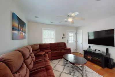 The main living area has a large comfortable movie couch and a huge smart TV