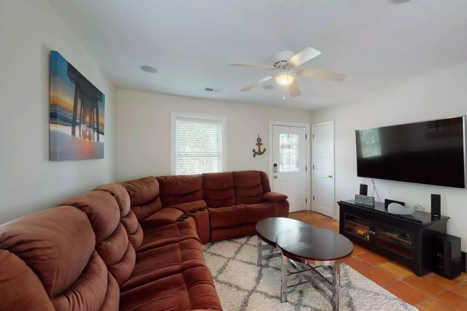 The main living area has a large comfortable movie couch and a huge smart TV