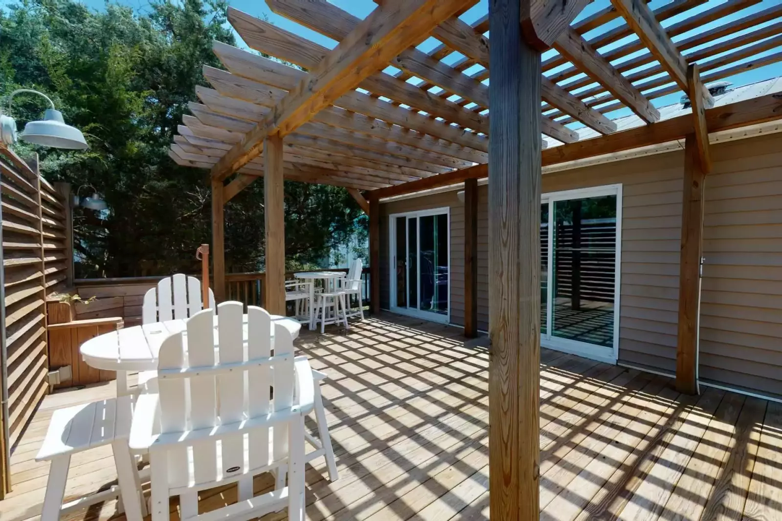 The large deck has a pergola providing shade on those hot sunny days