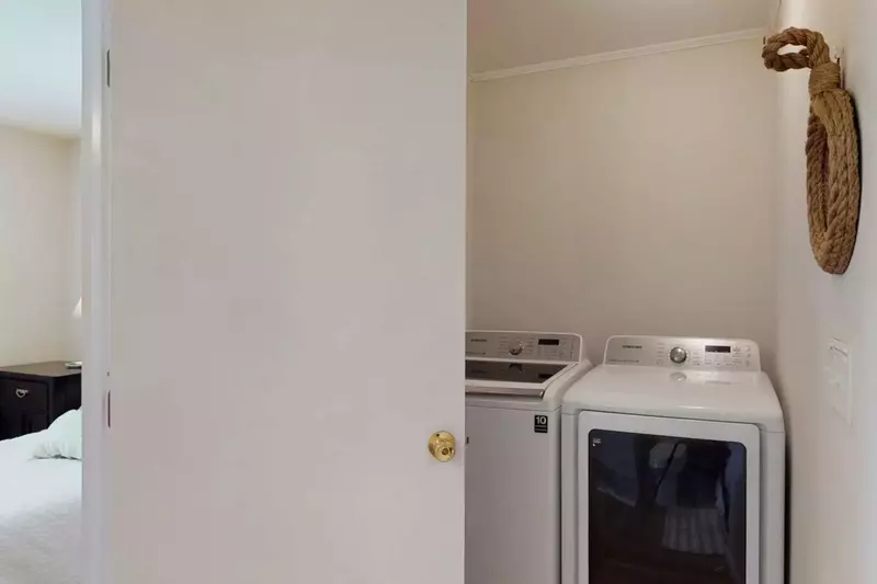 The updated laundry appliances are located in the en-suite bathroom