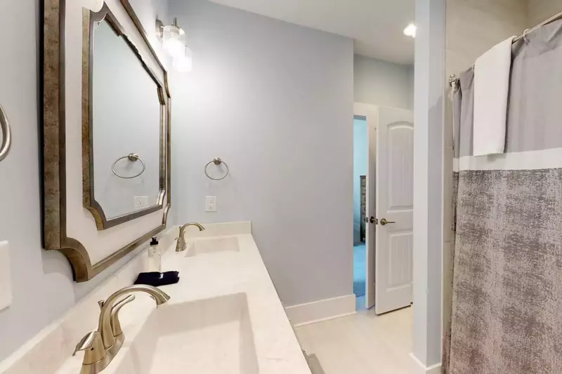 2nd floor hall bathroom has a tub shower and 2 sinks