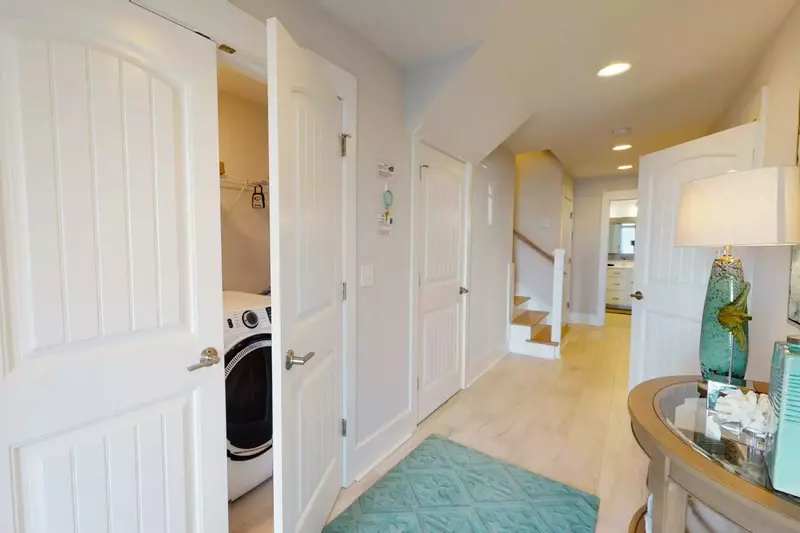 Cary Me Away has a great hall entrance with a laundry area with new front load washer and dryer