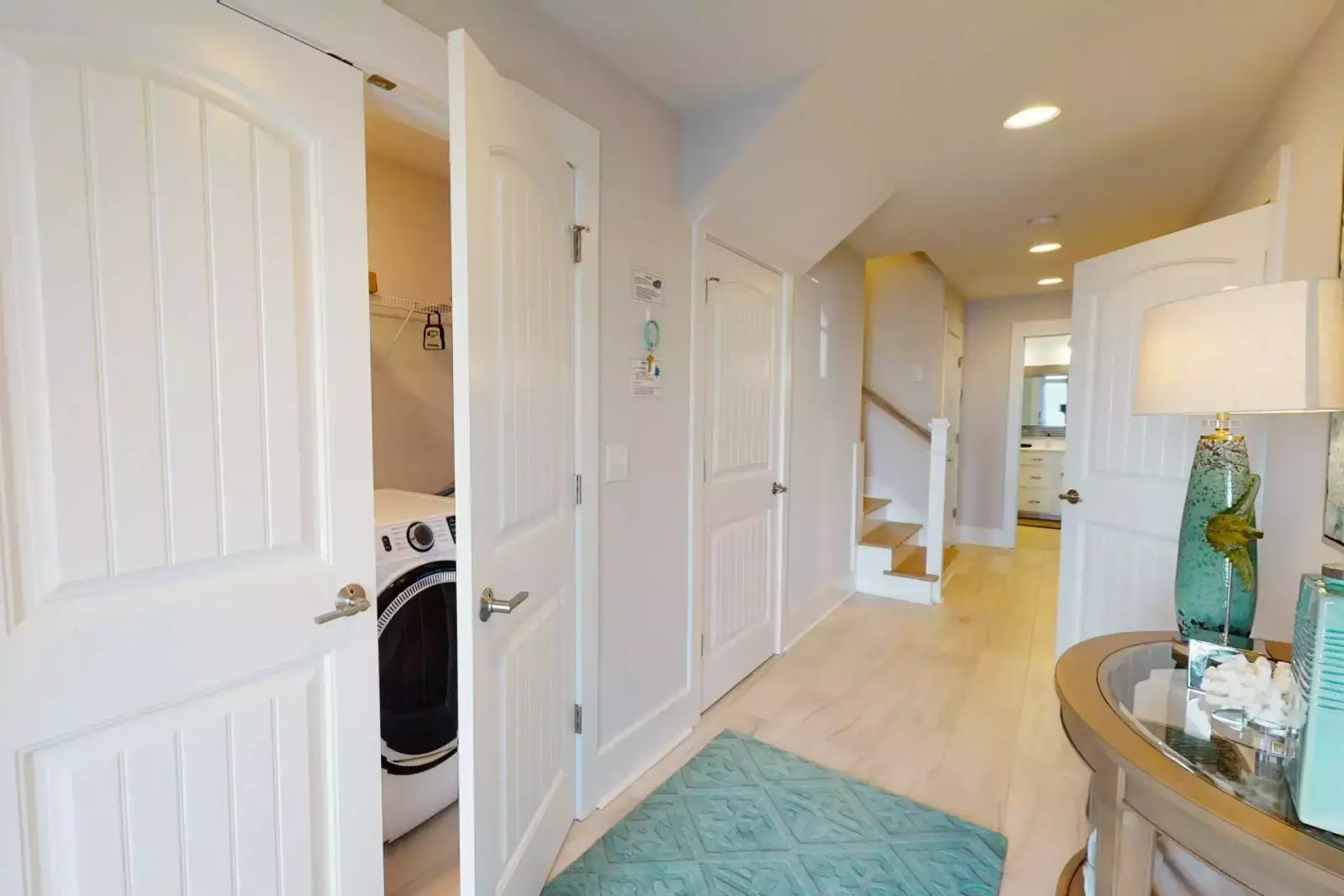 Cary Me Away has a great hall entrance with a laundry area with new front load washer and dryer