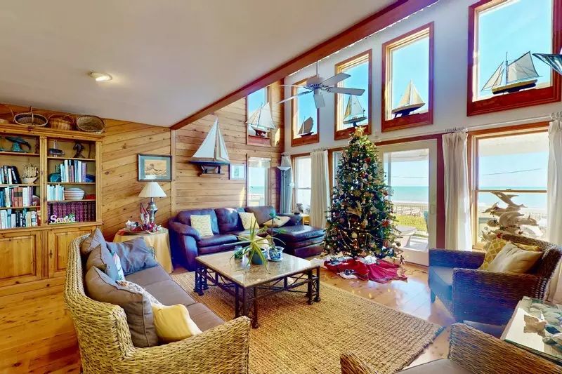 The main living area features nautical decor and tons of natural light