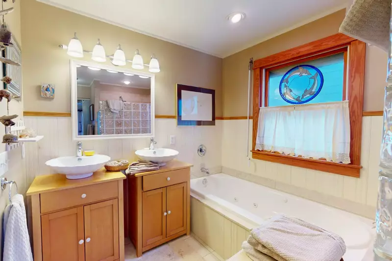 The primary ensuite features a jetted tub, walk in shower and double vanities