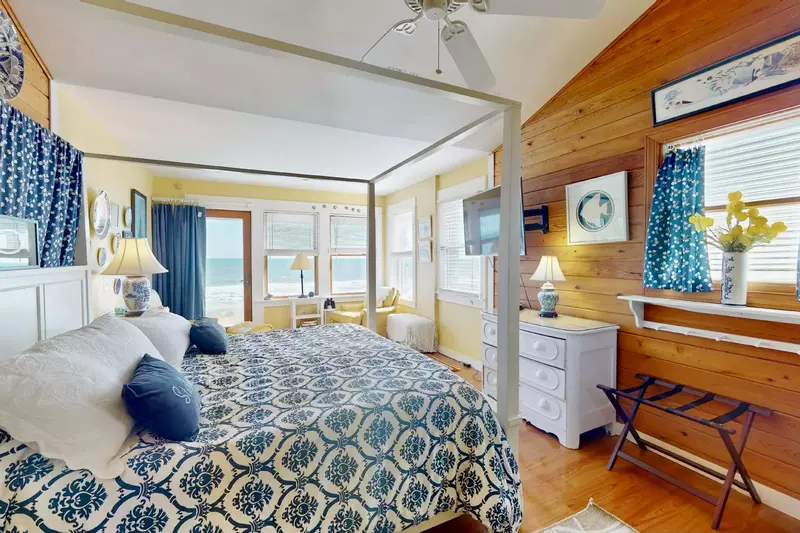 This second bedroom features a king bed, ocean view and sitting area