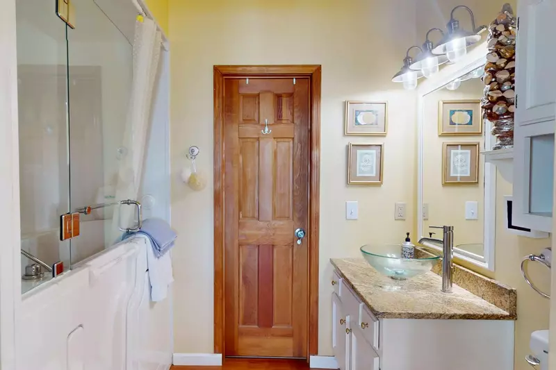 The top floor king bedroom has an ensuite with available toilet + sink. (Shown shower is not available to guests)