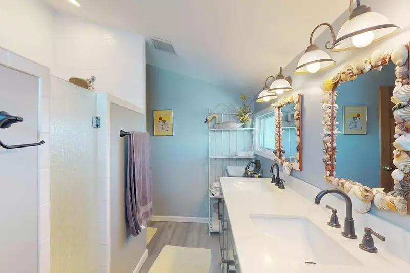This top floor hall bathroom has a walk in shower and double sinks