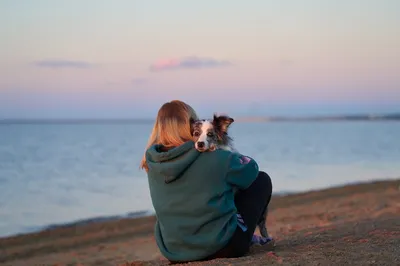 woman with dog on beach