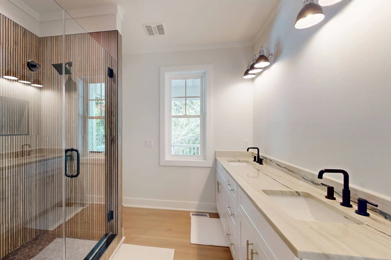 1st floor ensuite offers double sinks and a custom walk in shower with a rainfall showerhead