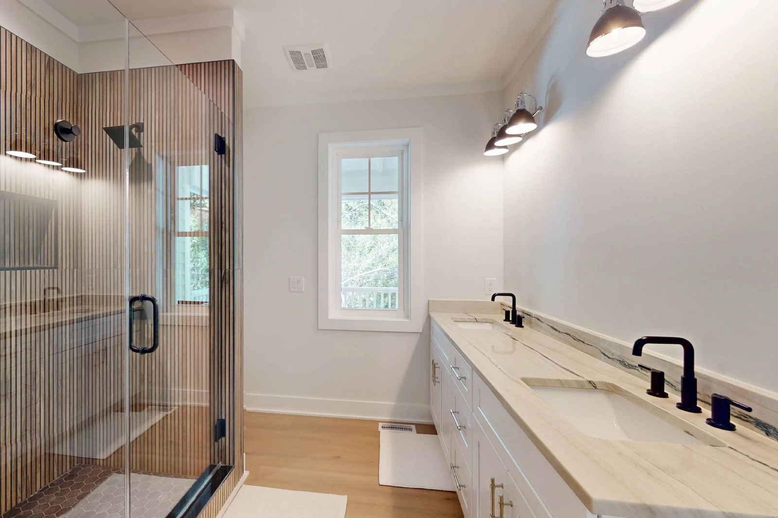 1st floor ensuite offers double sinks and a custom walk in shower with a rainfall showerhead