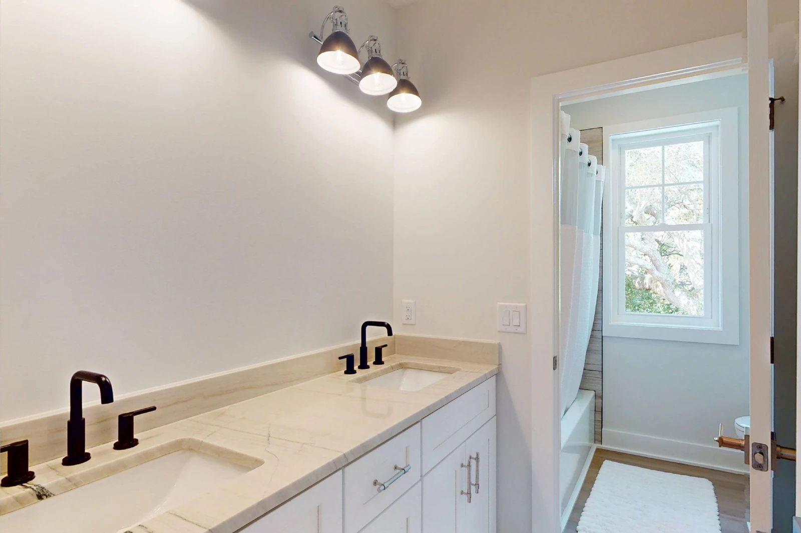 The upstairs hall bathroom offers double sinks (mirrors to be installed soon)