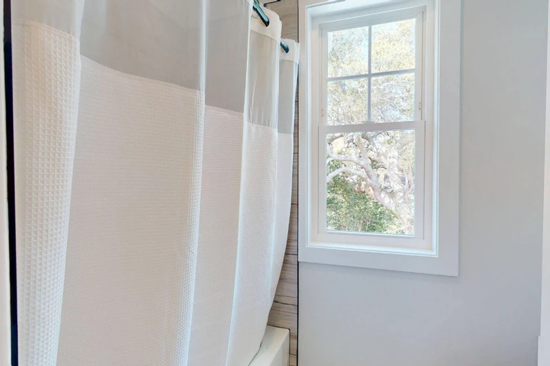 The upstairs hall bathroom has a tub/shower combo and toilet area that can be closed off from the vanity