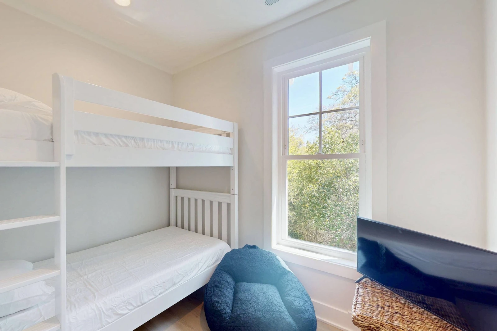 The bunk room offers XL twin over XL twin beds, a tv and a fun beanbag chair