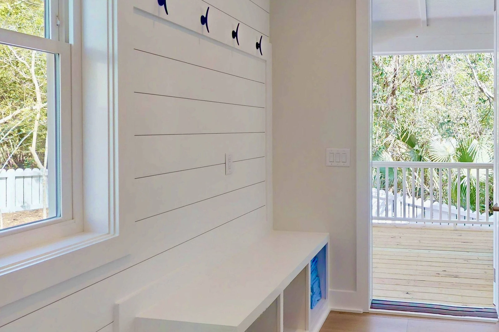 The entryway offers a spot to place shoes, jackets and bags