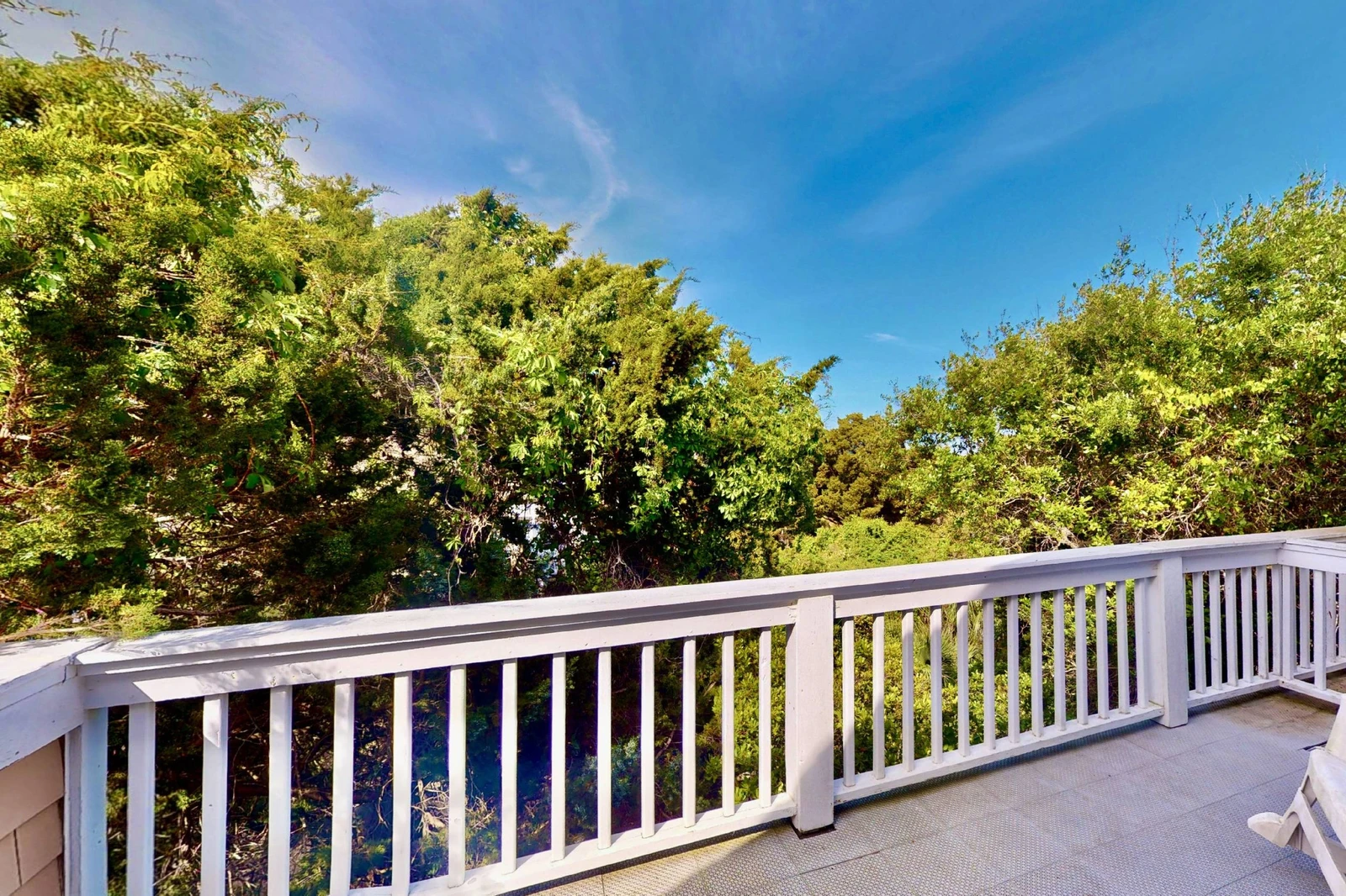 A second top floor deck offers forest views