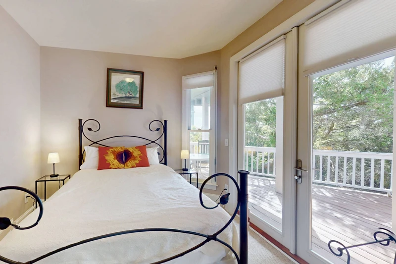The third bedroom has a queen bed, direct deck access and a nearby hall bathroom
