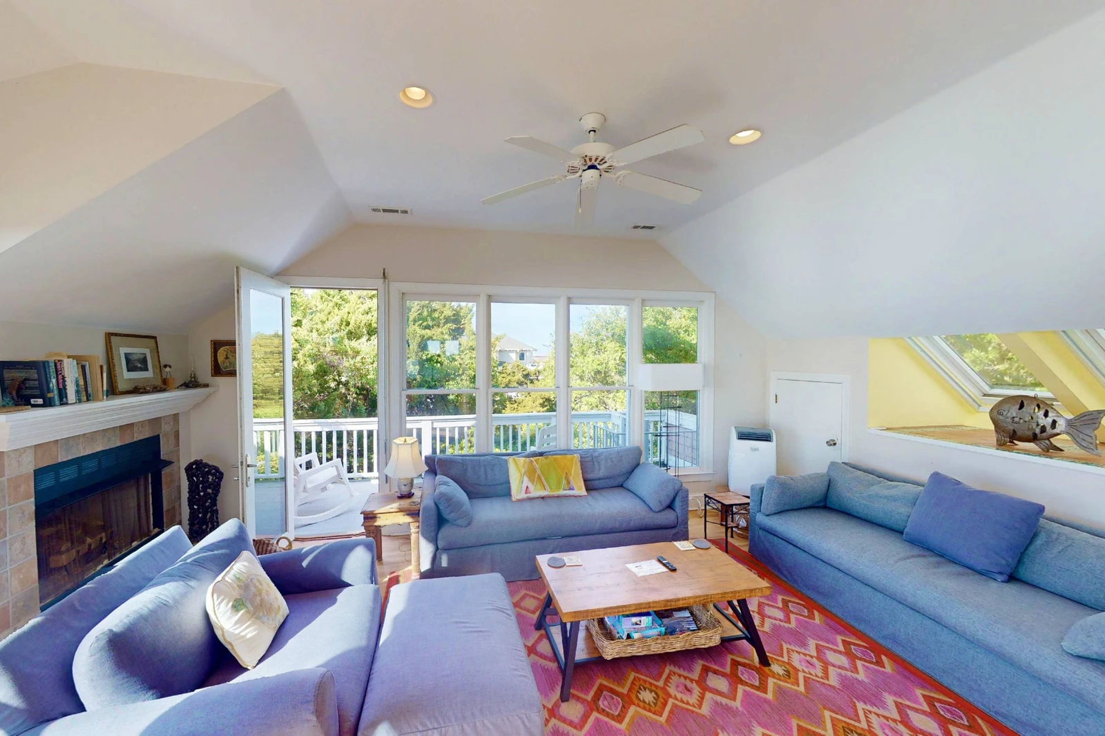 The living room opens to a second top floor deck with seating