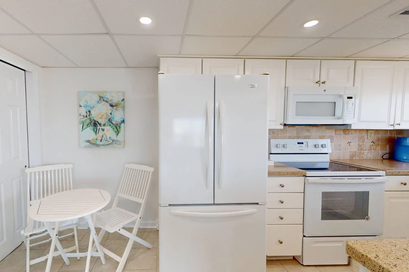 A small table with seating for 2 is located just outside the kitchen