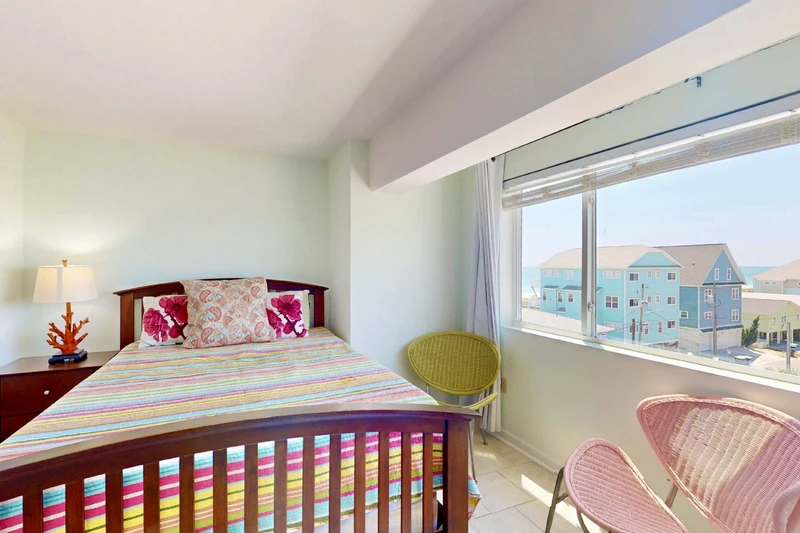 The owner's suite features a queen bed and large windows for lots of natural light
