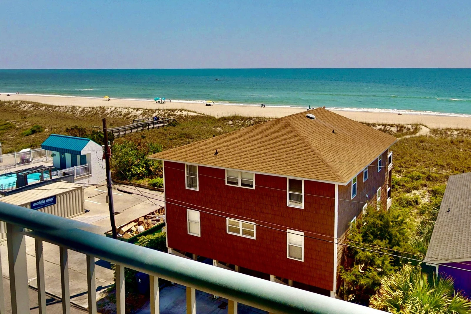The nearby beach access is visible from the balcony