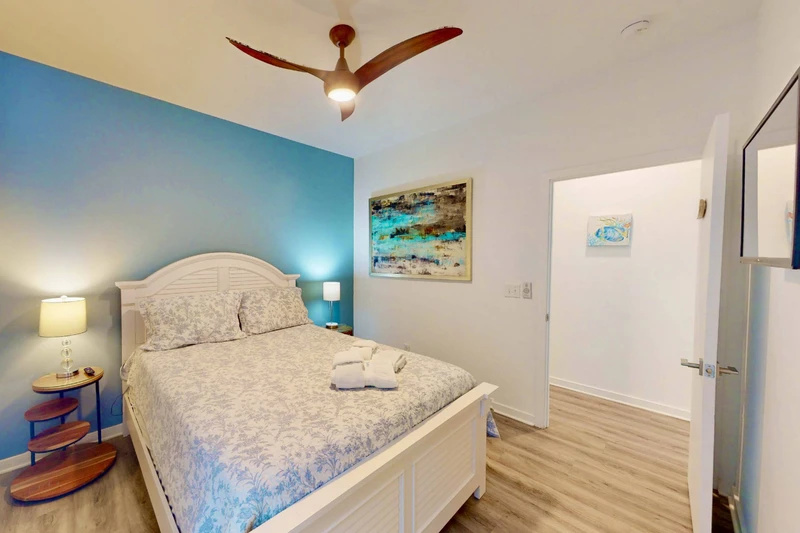 Bedroom 3 with a queen bed and wall mounted tv