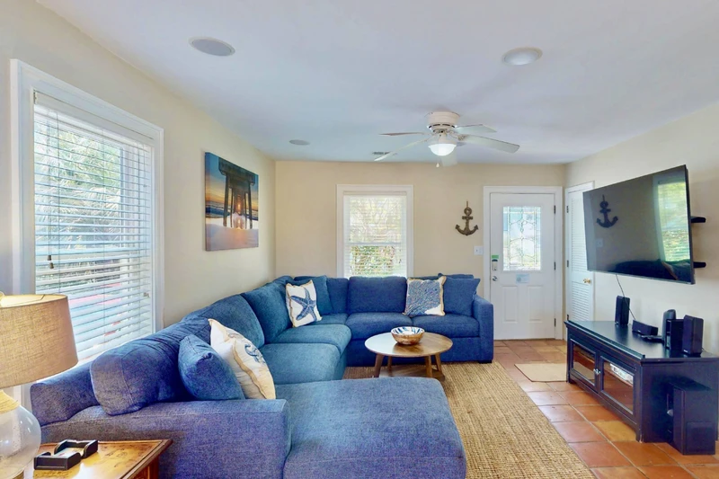 The main living area has a new sectional couch and a large smart TV