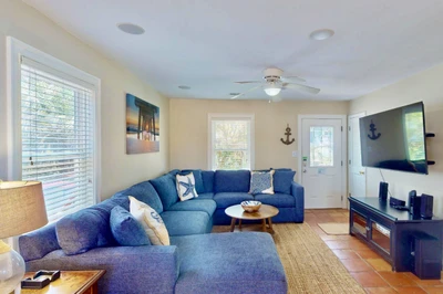 The main living area has a new sectional couch and a large smart TV
