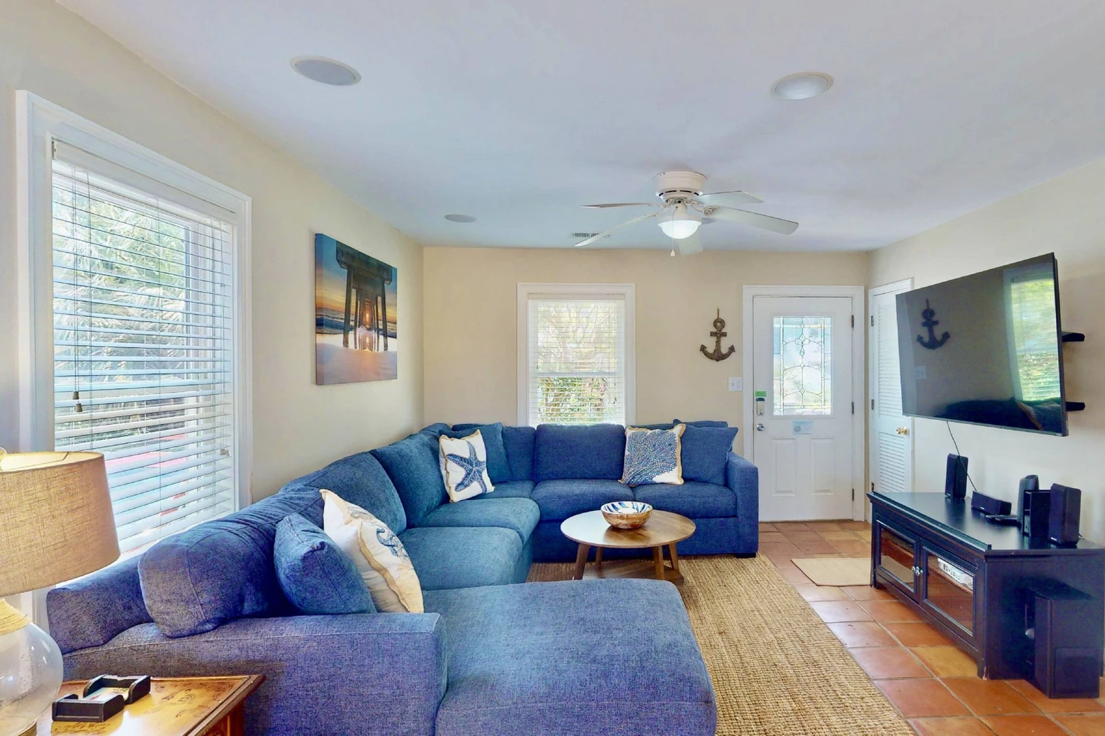 The main living area has a new sectional couch and a large smart TV