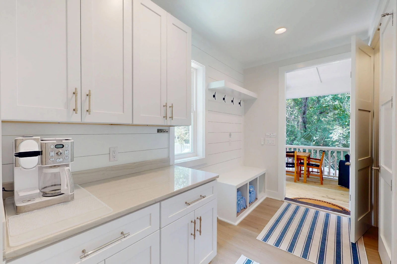 Even more counter space and cabinets are tucked next to the kitchen along with the entryway, a great spot to place shoes, jackets and bags
