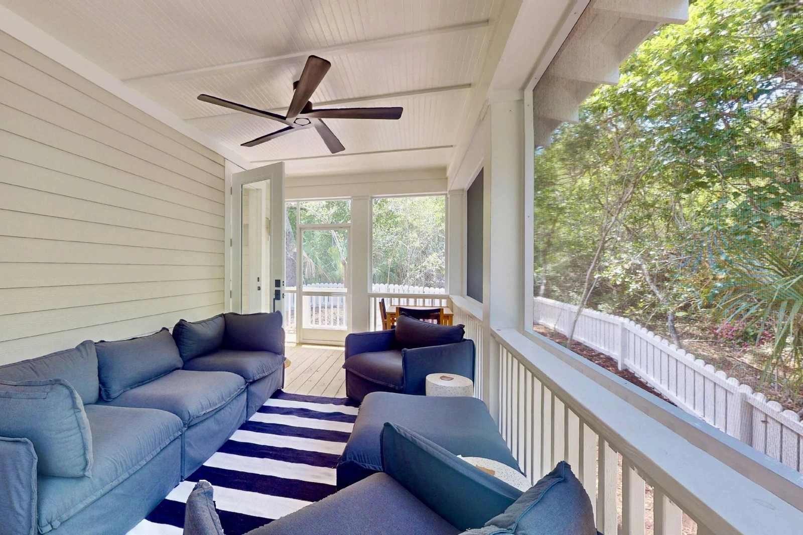 The screened in porch offers plenty of seating