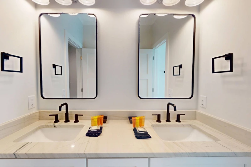 The upstairs hall bathroom offers double sink