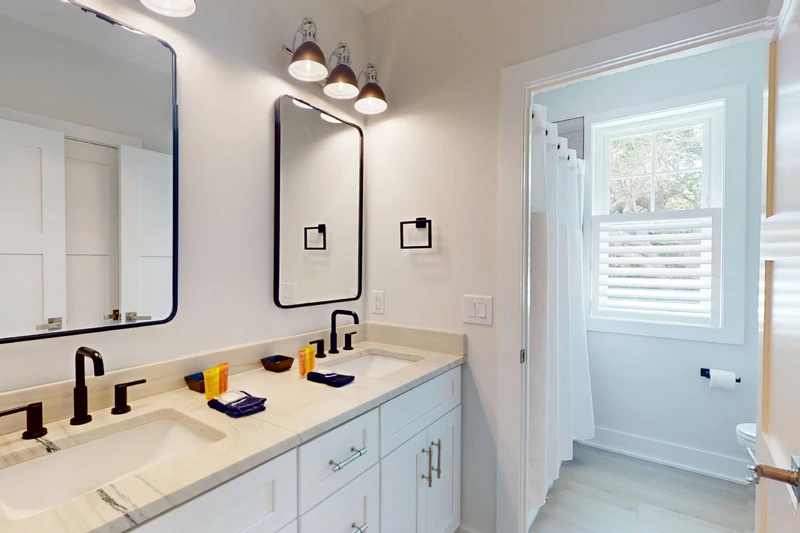 The upstairs hall bathroom has a tub/shower combo and toilet area that can be closed off from the vanity area