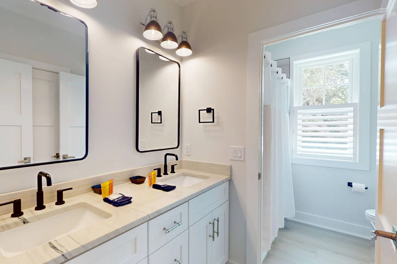 The upstairs hall bathroom has a tub/shower combo and toilet area that can be closed off from the vanity area