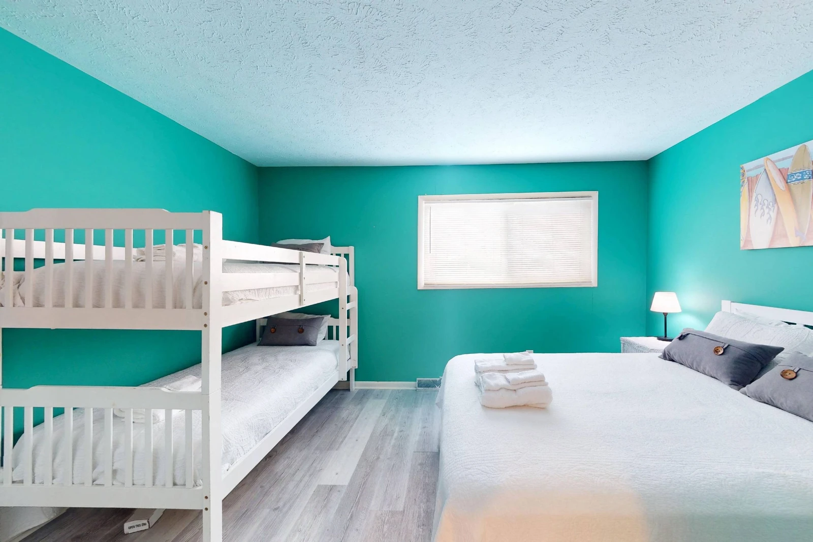 Bedroom 3 features a queen bed, twin over twin bunk beds and an en-suite