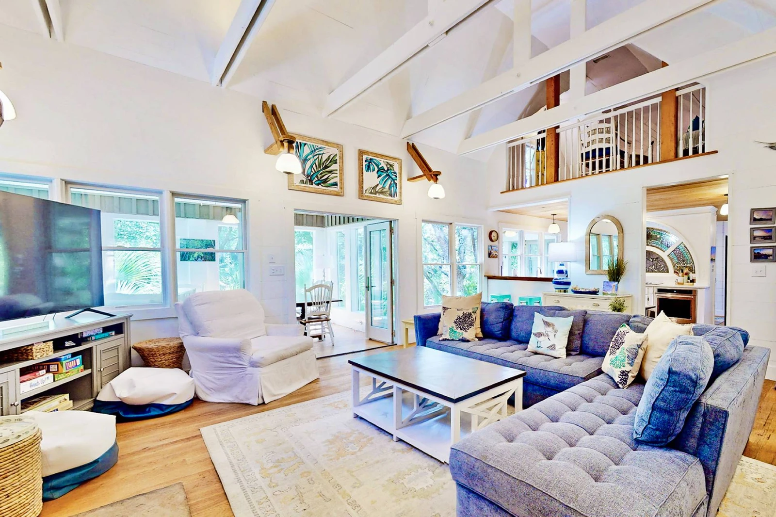 The living room is open with high vaulted ceilings