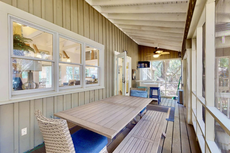 The large table on the screened in sun room is great for meals, games or chatting