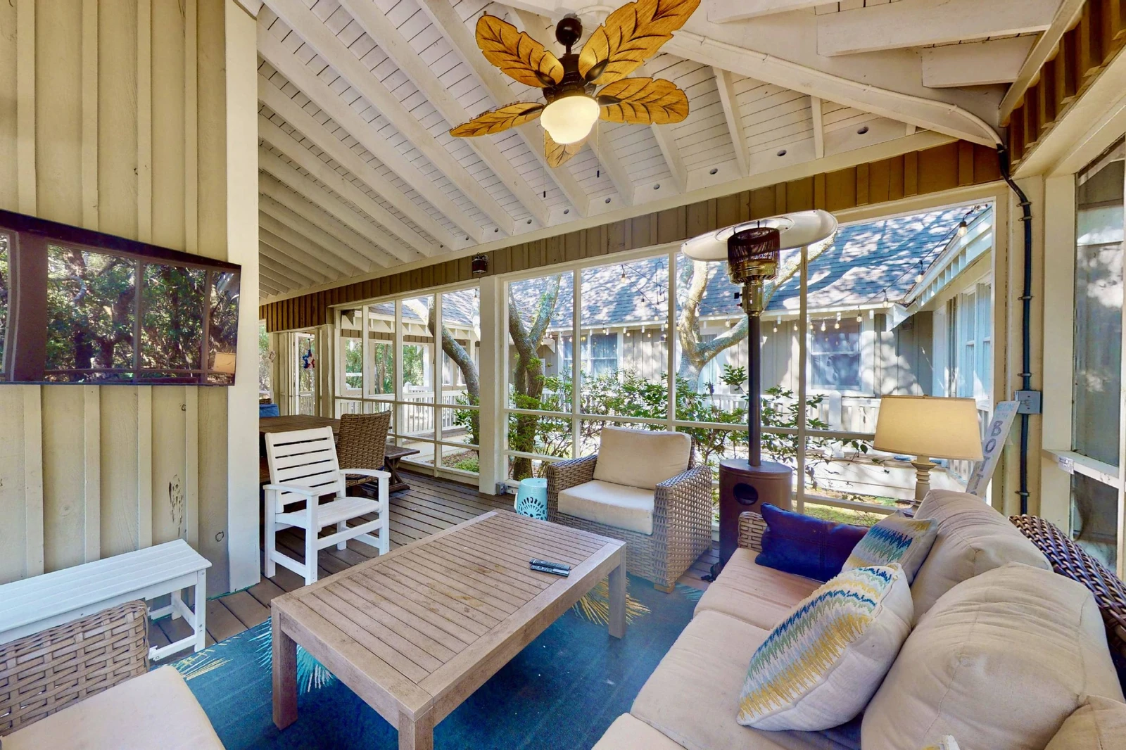 A tv on the screened in sun room is a perfect spot to spend those weekends watching football!