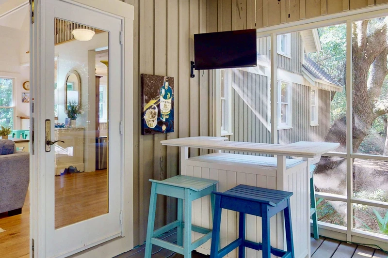 Mix some drinks at the bar on the screened in sun room