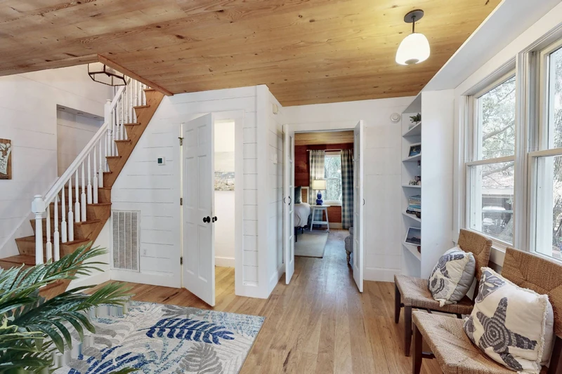 A charming sitting area connects the kitchen, stairs, half bath and owner's suite