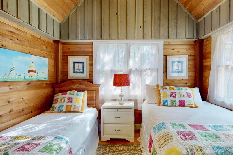 The third bedroom in the guest wing (accessed through the second queen room) has a double bed and a twin bed