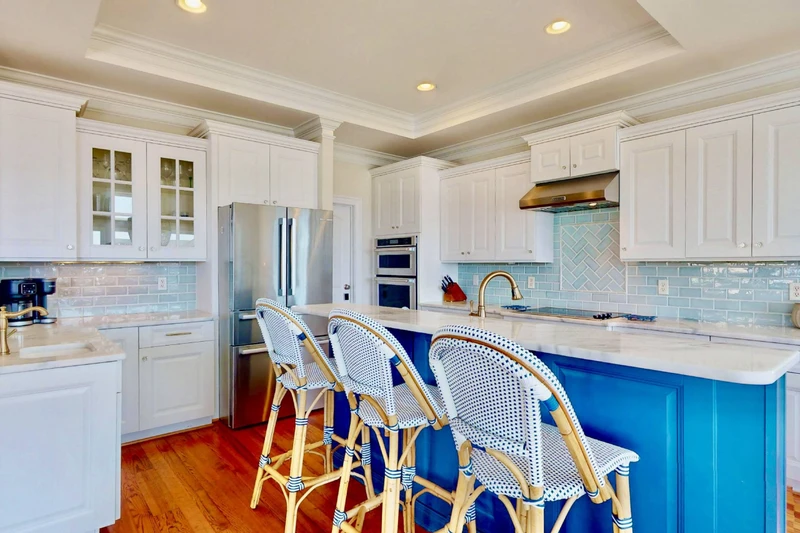 The bright kitchen offers extra counter seating and stainless steel appliances