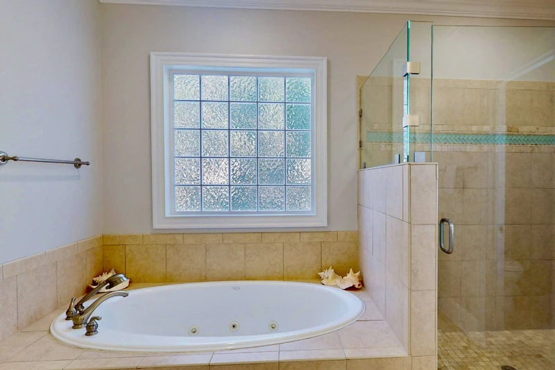 The owner's ensuite features a large soaking tub and a walk in shower