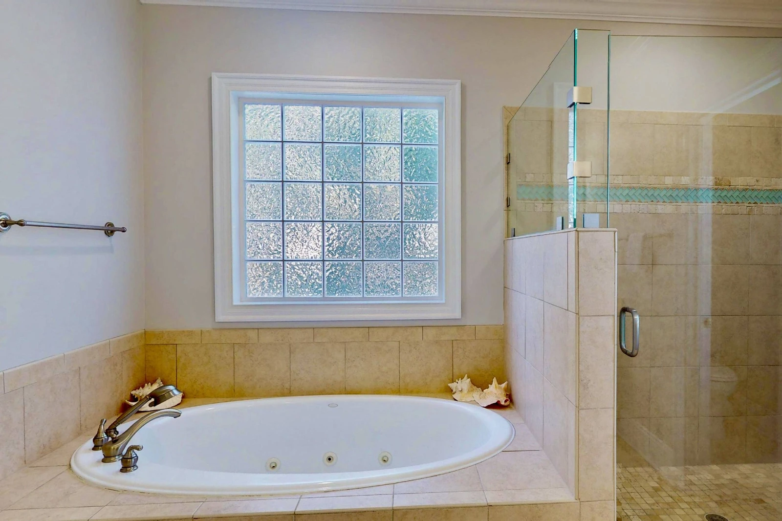 The owner's ensuite features a large soaking tub and a walk in shower