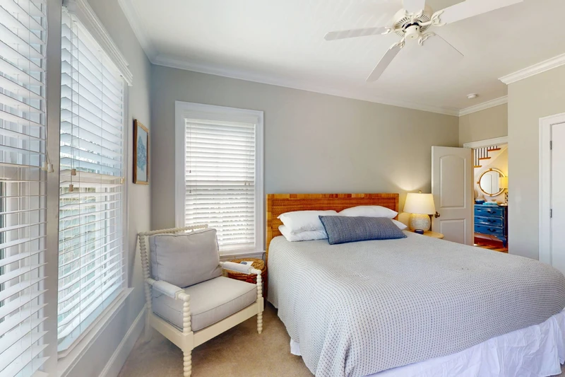Bedroom 2 is on the second floor with a queen bed, direct access to a private porch and is next door to the hallway bathroom