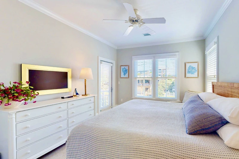This bedroom also offers a wall mounted tv and a small sitting area